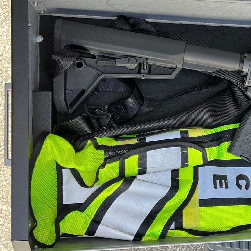 Chevy/GMC Gear-Guard Under-Seat Locker with the door open with the carpet option showing how it can be used. The locker is a high-quality powder coated galvanealed steel.
